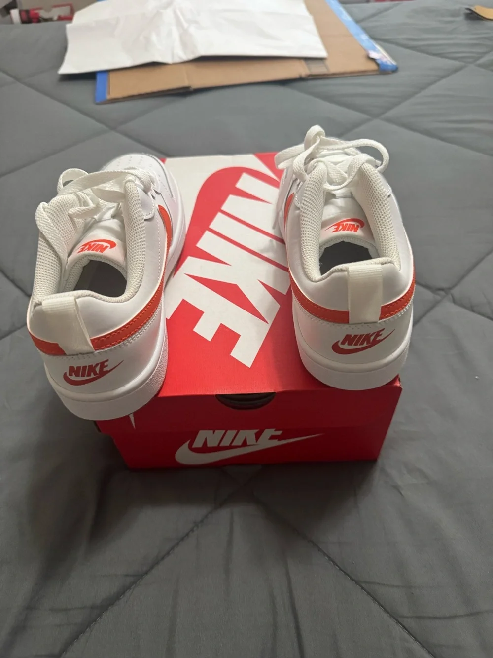 Nike Kids White Sneakers with Orange Swoosh Accent
